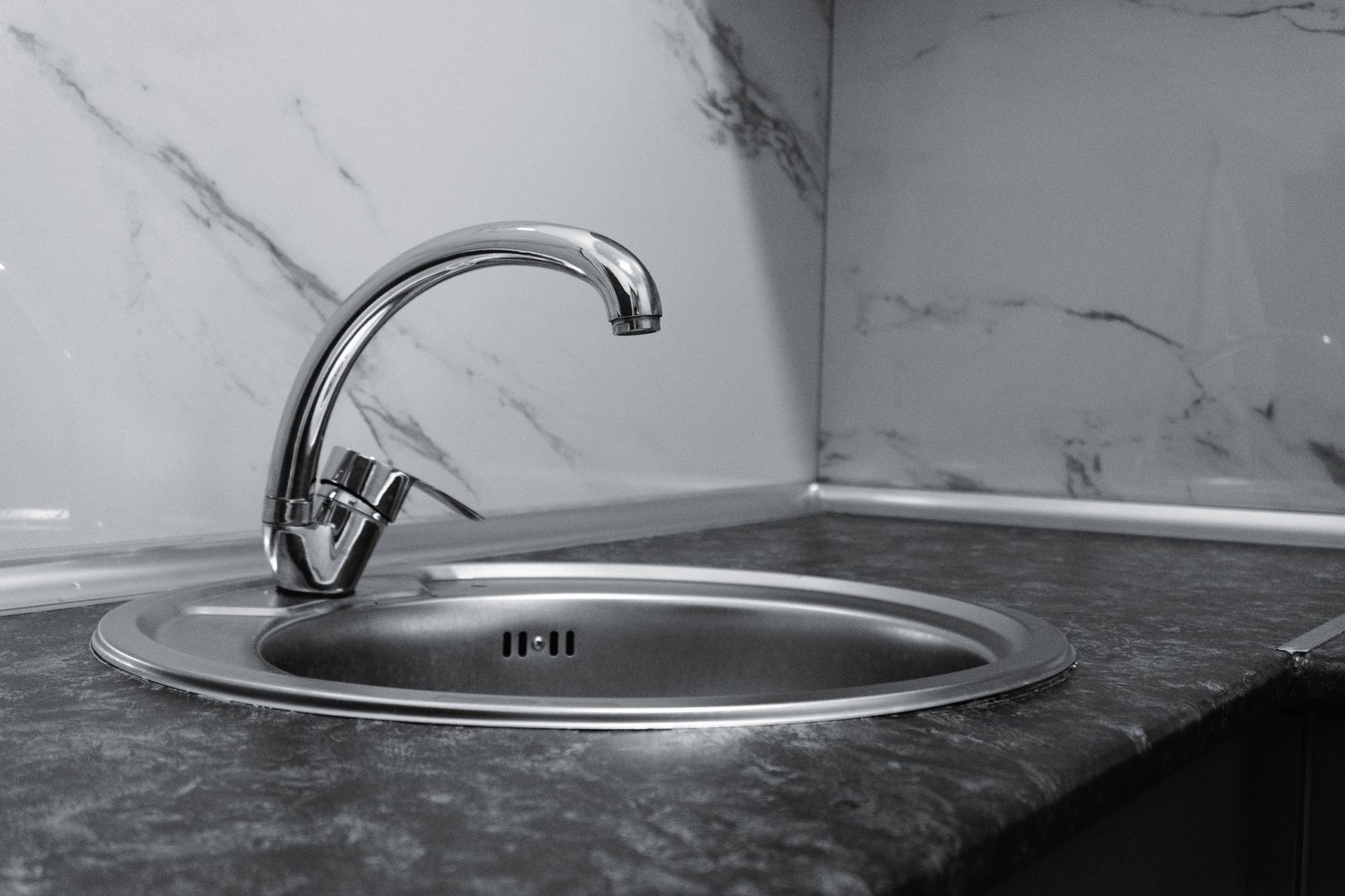 Stainless steel kitchen sink of the kind a garbage disposal mounts under