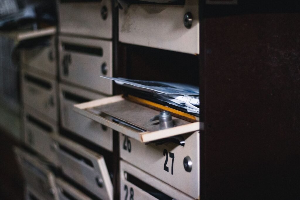 Close-up of an open residential mailbox with mail inside